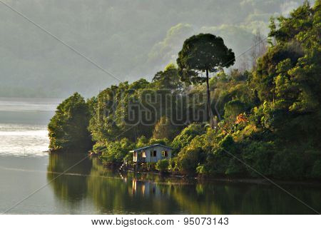 Abandon Old Wodden Hut Basked In Morning Sunlight At A Shore Of Magrove Cove In Tuaran, Sabah, Malay
