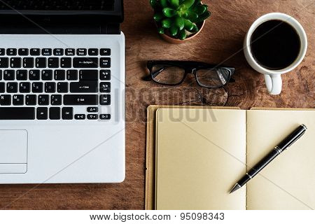 Laptop And Cup Of Coffee On Old Wooden Table