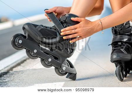 Woman in swimsuit with rollers on the highway