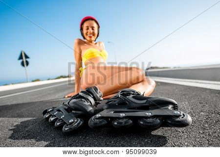 Woman in swimsuit with rollers on the highway
