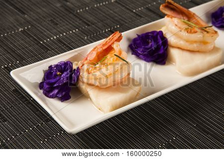 Grilled Shrimp With Raw Nail Fish On White Plate At Table