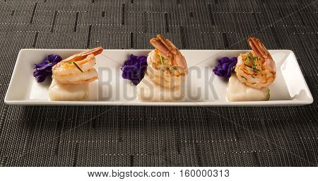 Grilled Shrimp With Raw Nail Fish On White Plate At Table