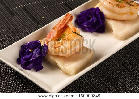 Grilled Shrimp With Raw Nail Fish On White Plate At Table