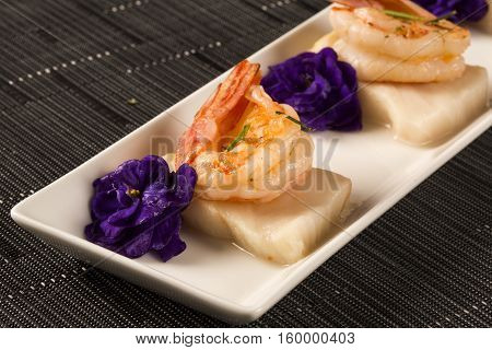 Grilled Shrimp With Raw Nail Fish On White Plate At Table