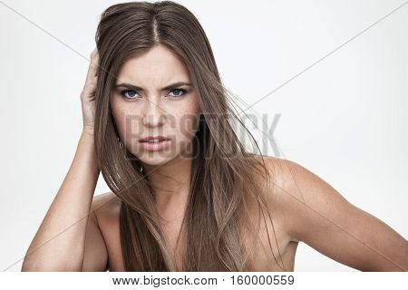 strong facial expression and emotion concept - young woman portrait with displeased negative grimace on her face