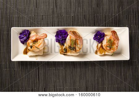 Grilled Shrimp With Raw Nail Fish On White Plate At Table