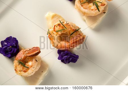 Grilled Shrimp With Raw Nail Fish On White Plate At Table