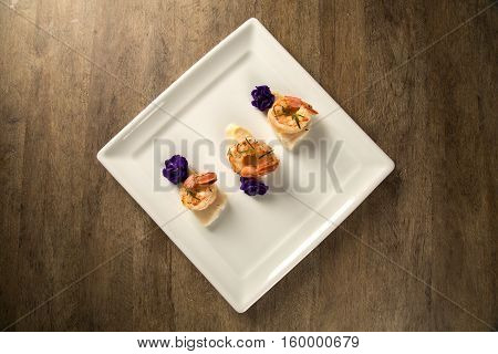Grilled Shrimp With Raw Nail Fish On White Plate At Table