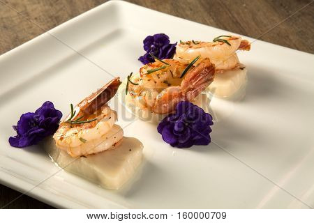 Grilled Shrimp With Raw Nail Fish On White Plate At Table