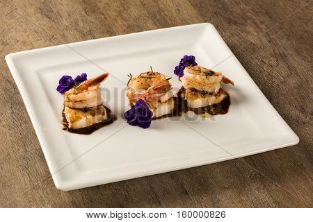 Grilled Shrimp With Raw Nail Fish On White Plate At Table