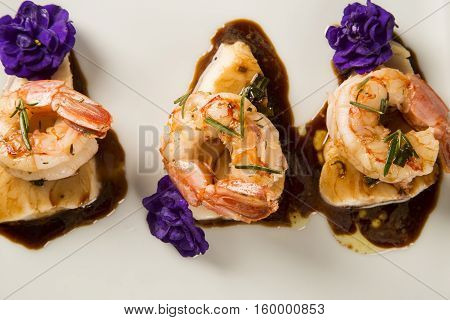 Grilled Shrimp With Raw Nail Fish On White Plate At Table