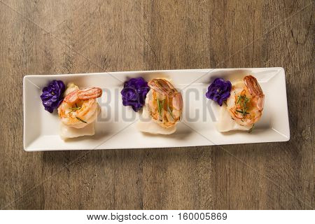 Grilled Shrimp With Raw Nail Fish On White Plate At Table