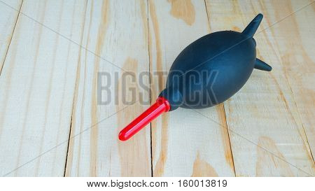 Handing air blower for cleaning lens on wooden