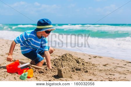 little boy play with sand on beach, family beach vacation