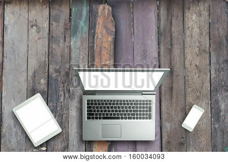 Top View Of Digital Laptop Computor, Tablet And Smartphone White Screen On Wooden Table Background.c