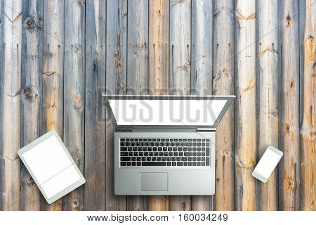 Top View Of Digital Laptop Computor, Tablet And Smartphone White Screen On Wooden Table Background.c