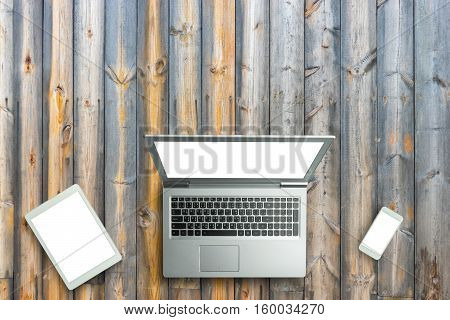 Top View Of Digital Laptop Computor, Tablet And Smartphone White Screen On Wooden Table Background.c