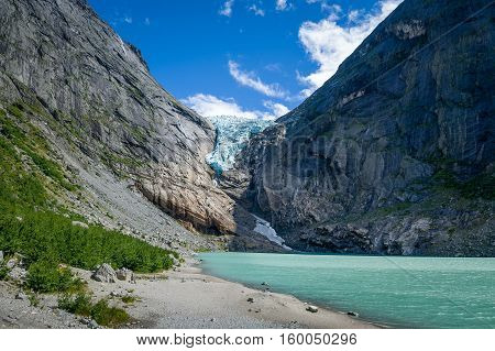 Briksdalsbreen glacier and lake with melted ice water. Popular Norway travel destination .