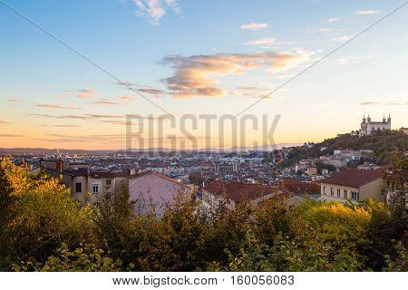 View of the city of lyon over rooftops with the cathedral of Fourvière