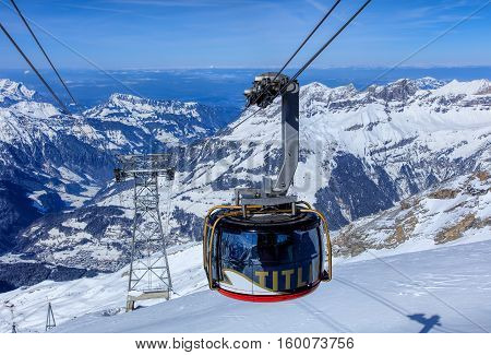 Mt. Titlis, Switzerland - 9 March, 2016: a gondola of the Rotair cable car, view from the station on the top of the mountain. Rotair gondolas make a 360 degrees turn during the five-minute trip.