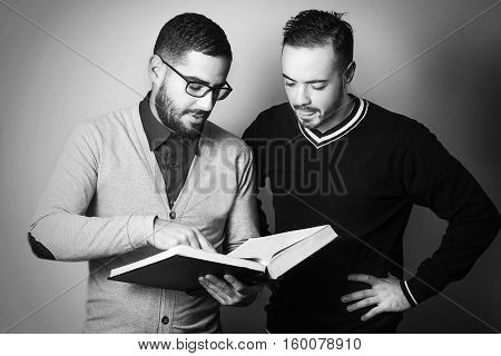 Two students are learning. Student is trying to teach other student a lesson. Team work. Retro