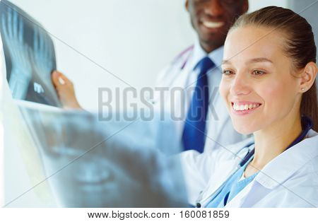 Doctors analyzing an x-ray in a meting