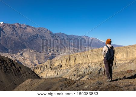 girl with a backpack looks at mountain pass Gyu La, Nepal