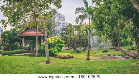Bangkok, Thailand - December 23, 2015: Panorama view of Bangkok skyline from Lumphini Park Thailand. Lumphini Park is a popular place for walks and sport activities.