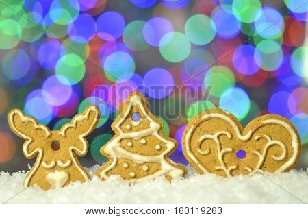 Delicious decorated Christmas cookies on bokeh background