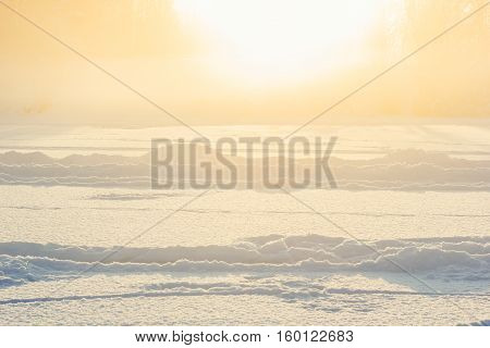Winter fog over the frozen river. A sudden fog on a cold day.