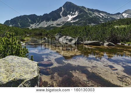 Reflection of Sivrya peak in Banski lakes, Pirin Mountain, Bulgaria