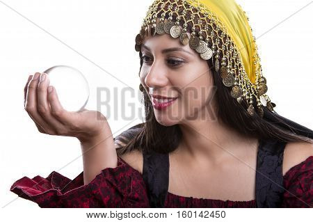 Close up of female fortune teller or psychic with clear crystal ball for composites. Facial expressions indicate she is seeing a vision on in the orb.