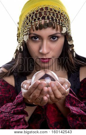 Close up of female fortune teller or psychic with clear crystal ball for composites. Facial expressions indicate she is seeing a vision on in the orb.