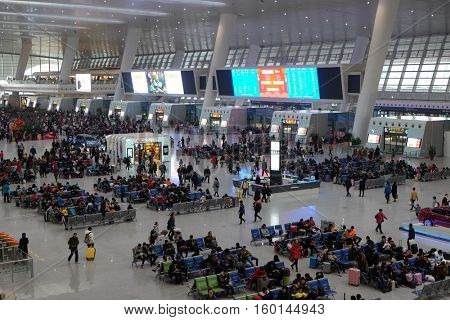 HANGZHOU - FEBRUARY 21: Passengers waiting for the train in the hall. Hangzhou East railway station is one of the largest railway hub in Asia, in Hangzhou, China, February 21, 2016.