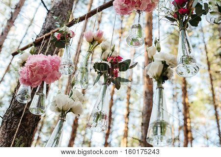 Wedding flowers decoration arch in the forest. The idea of a wedding flower decoration. wedding concept in nature.