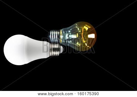 Led light bulb on dark background with Blurred incandescent light bulb and copy space on the right screen
