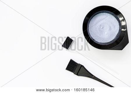 Tools for hair dye and hairdye top view on white background