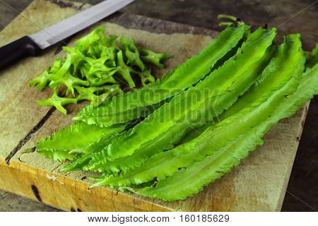 Winged beans on wooden background, Princess bean, Goa bean