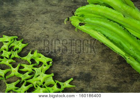 Winged beans on wooden background, Princess bean, Goa bean