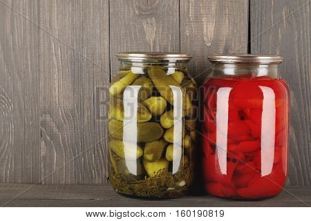 canned vegetables in glass jars on a wooden background home food storage