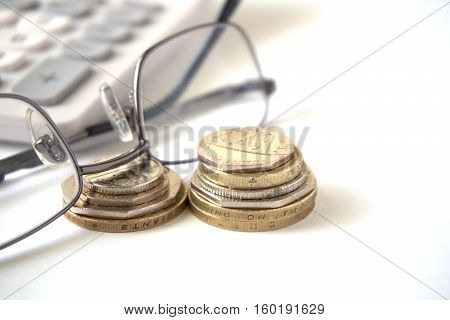 Coins with glasses on top and calculator