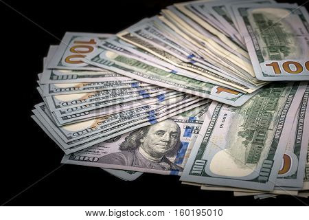 100 us dollar biils on  isolated black
