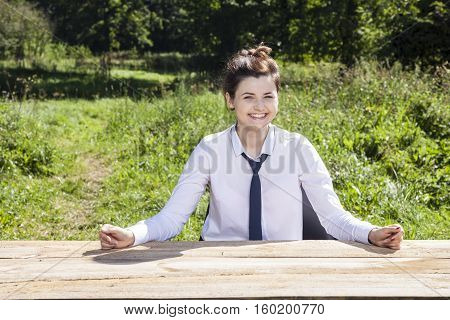 Smiling Business Woman Shows Her Desk