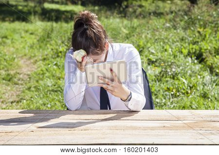 Depressed Business Woman Eating An Apple And Reading Messages