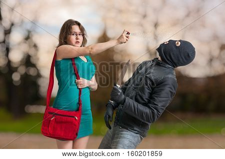Young Woman Is Defending With Pepper Spray Against Armed Thief W
