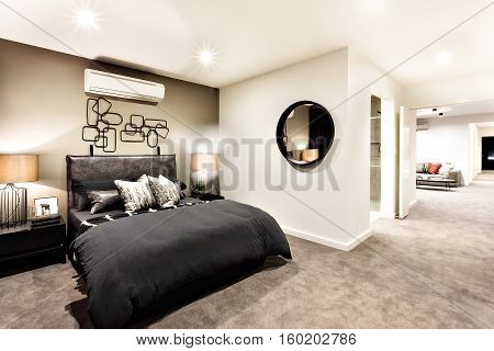 Modern bedroom with a hallway to other rooms and illuminated with night lights