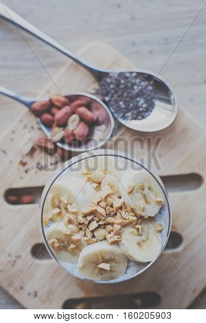 Banana chia yogurt pudding decorated with ripe sliced banana and peanuts