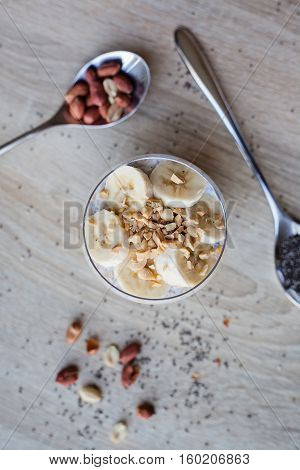 Banana chia yogurt pudding decorated with ripe sliced banana and peanuts