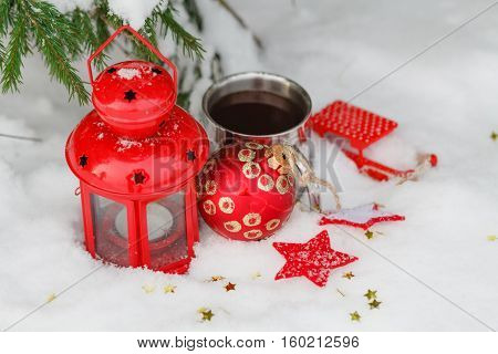 Old Mug With A Hot Drink And With A Fir-cone In The Snow In The Outdoors.