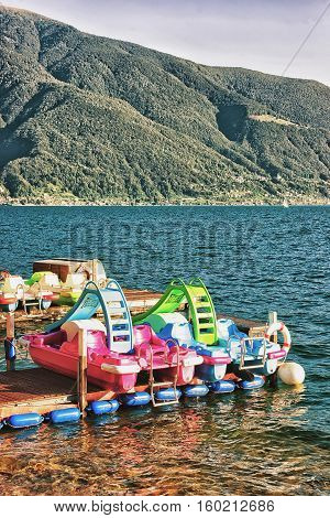 Ascona, Switzerland - August 25, 2016: Catamarans at the promenade of the luxurious resort Ascona on Lake Maggiore in Ticino canton in Switzerland.